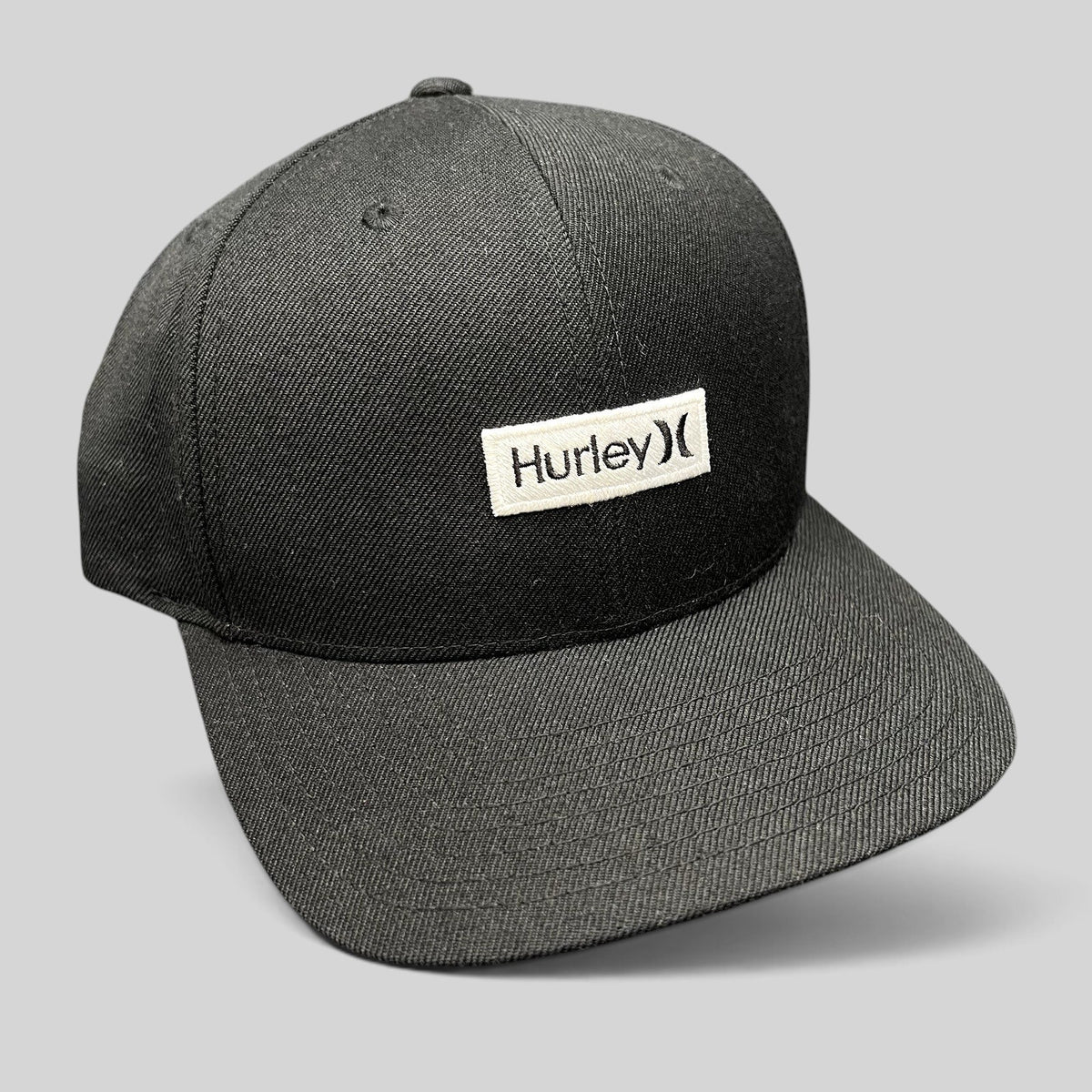 Raree Finds black Hurley snapback hat with a woven logo patch on a structured Yupoong The Classics crown.