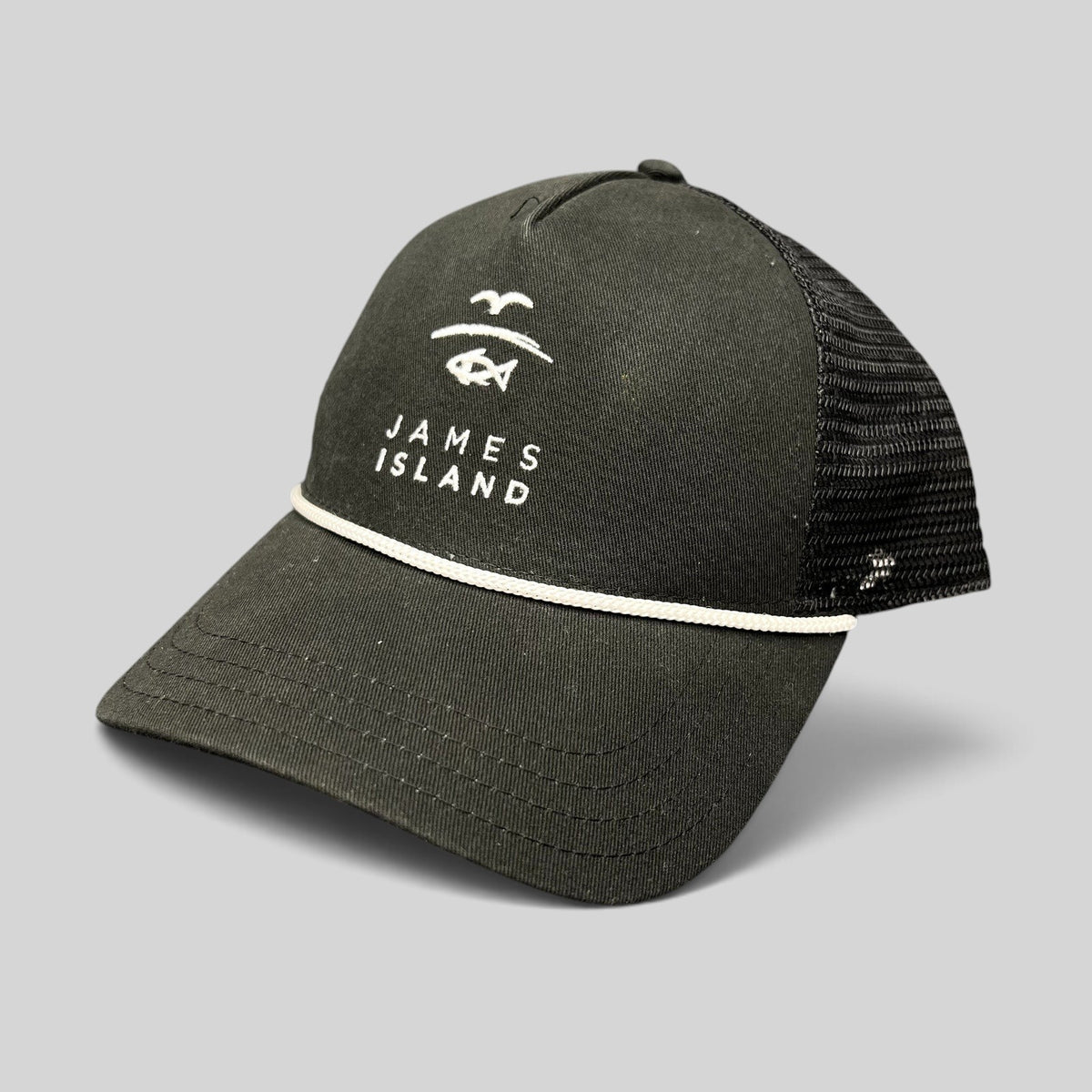 Raree Finds black trucker hat with white James Island coastal embroidery, structured crown, and breathable mesh back.