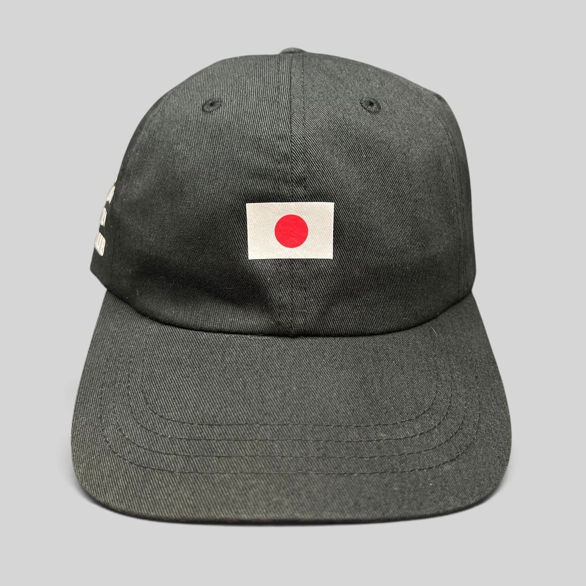 Raree Finds black cotton strapback hat featuring a centered Japanese flag graphic on the front