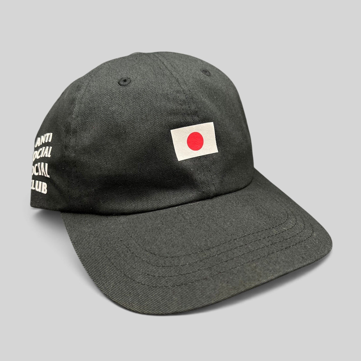 Raree Finds black Anti Social Social Club strapback hat with a Japanese flag graphic on the front