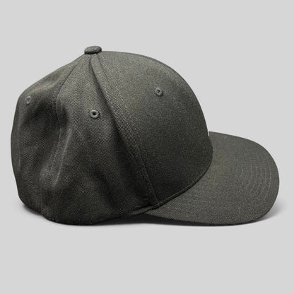 Raree Finds black Kangol flexfit baseball cap with a structured crown and curved brim in a side profile view.