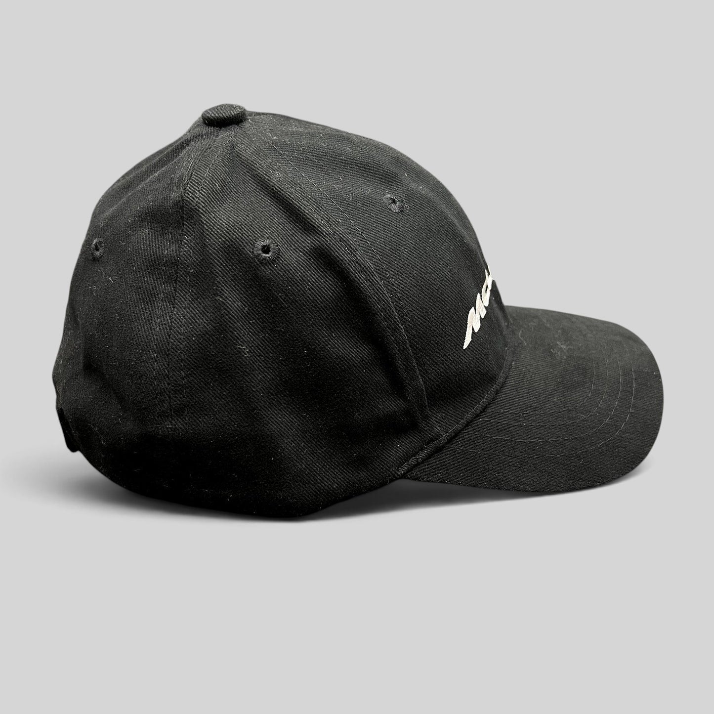 Raree Finds black McLaren cotton strapback hat with white embroidered logo, side profile view of 6-panel cap.