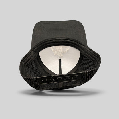 Raree Finds black mesh trucker hat showing the interior structure, adjustable snapback closure, and embroidered logo.