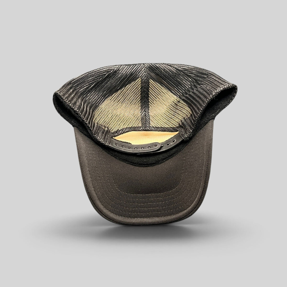 Raree Finds black trucker hat with breathable mesh back and adjustable snapback closure viewed from the rear