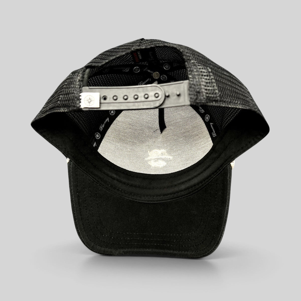 Raree Finds black trucker hat from the Discovery Collection with a breathable mesh back and adjustable snapback closure