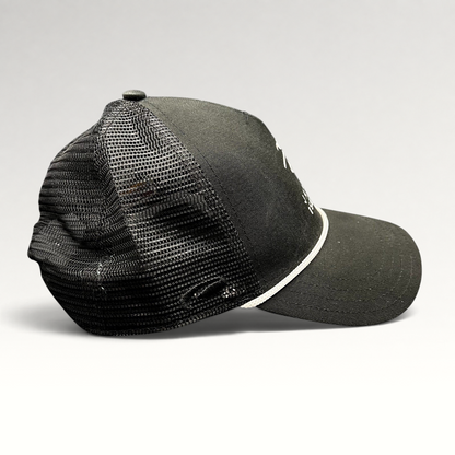 Raree Finds black trucker hat with mesh back, white embroidered coastal logo, and adjustable snapback closure.