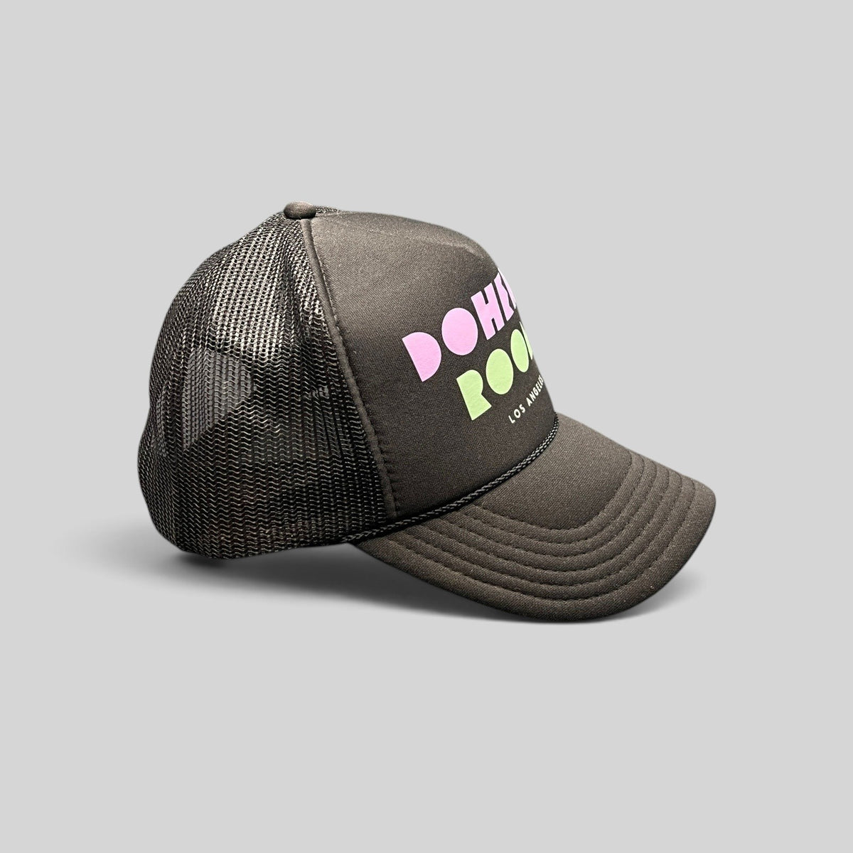 Raree Finds black mesh trucker hat with Doheny Room pastel logo on structured foam front and curved brim