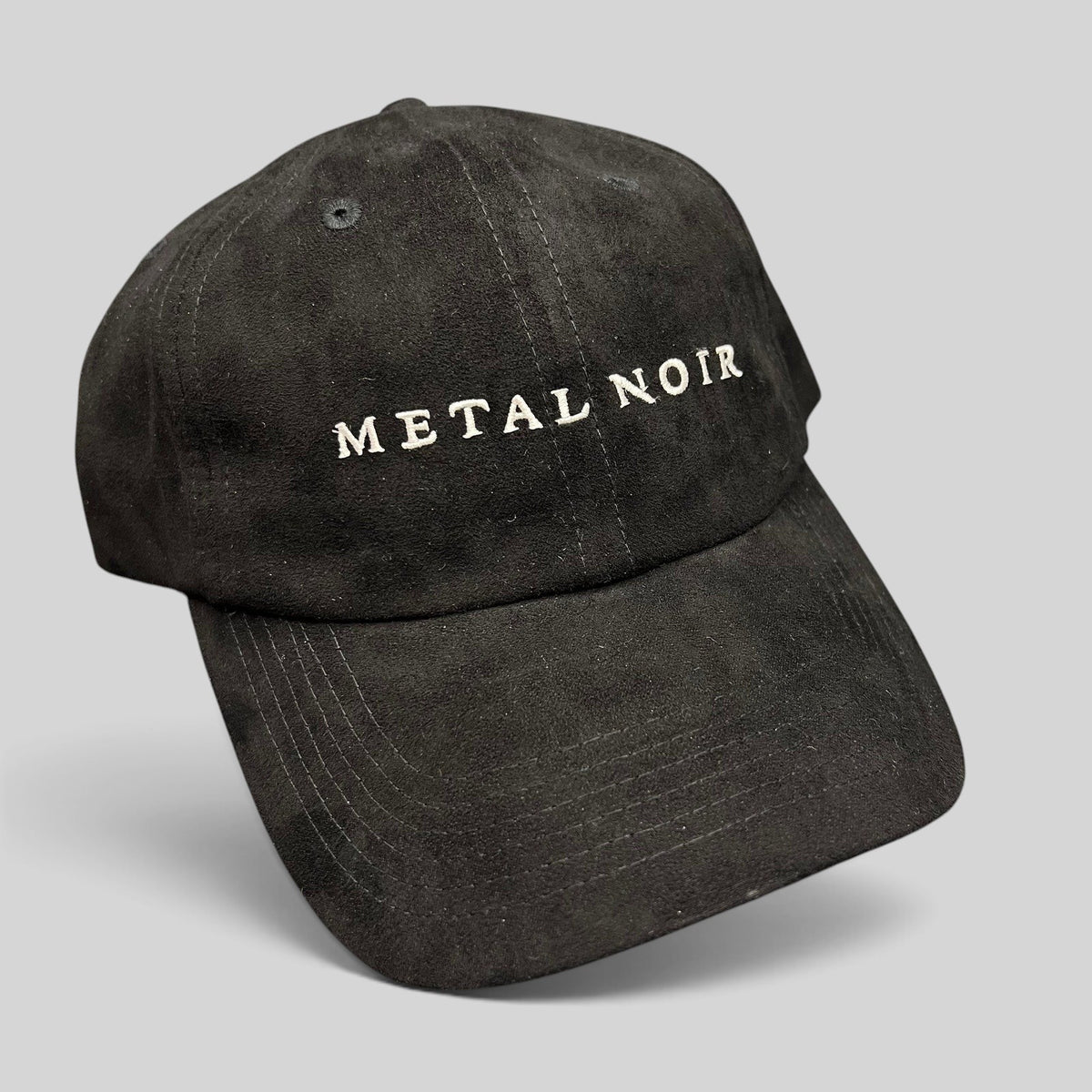 Raree Finds black unstructured strapback hat with white Metal Noir embroidery and a soft suede-like finish