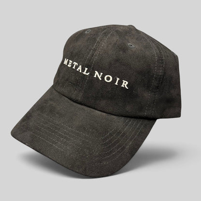 Raree Finds black unstructured strapback hat with white Metal Noir embroidery and a soft suede-like cotton finish.