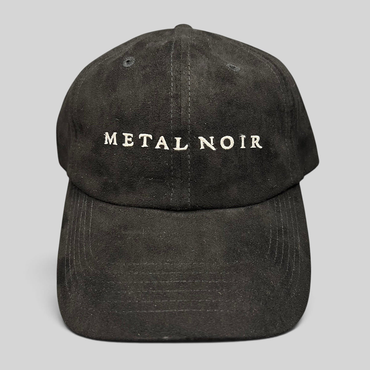 Raree Finds black unstructured strapback hat with white Metal Noir embroidery and a soft suede-like finish