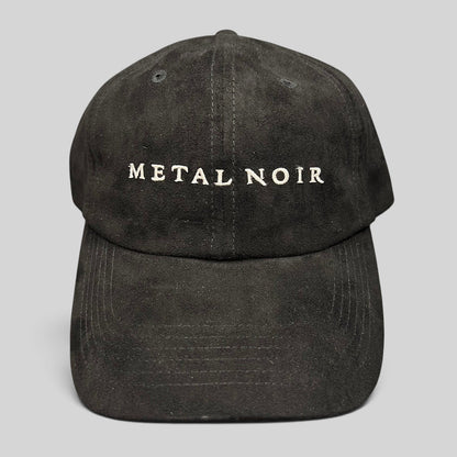 Raree Finds black unstructured strapback hat with white Metal Noir embroidery and a soft suede-like finish