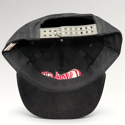 Raree Finds black cotton snapback hat with red Curdled metal band logo embroidery, showing adjustable back strap.