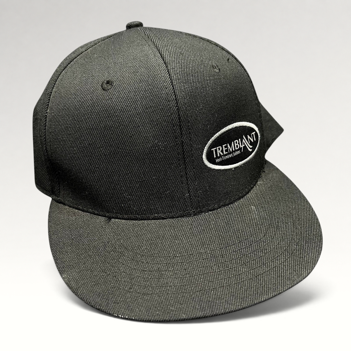 Raree Finds black Fits snapback hat featuring an embroidered white oval Mont Tremblant ski resort logo on the front.