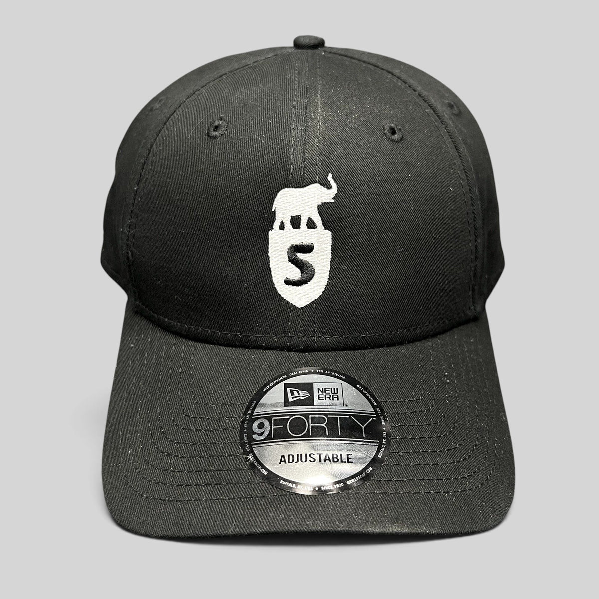 Raree Finds black New Era 9FORTY strapback hat with white embroidered elephant and shield crest logo on front