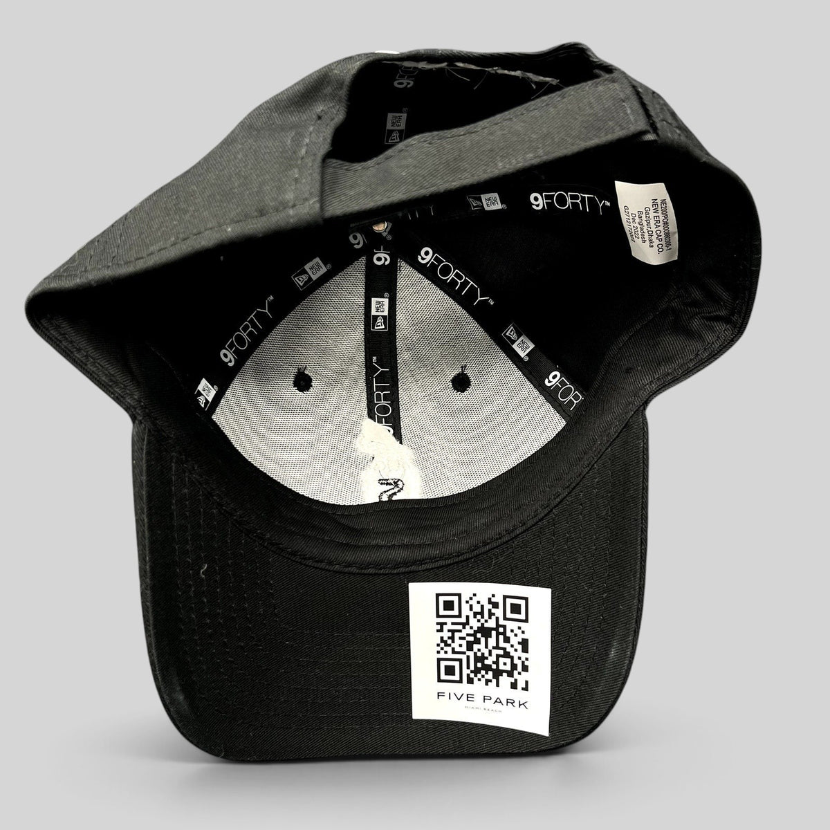 Raree Finds black New Era 9FORTY strapback hat interior view showing branding and Five Park Miami Beach QR code tag