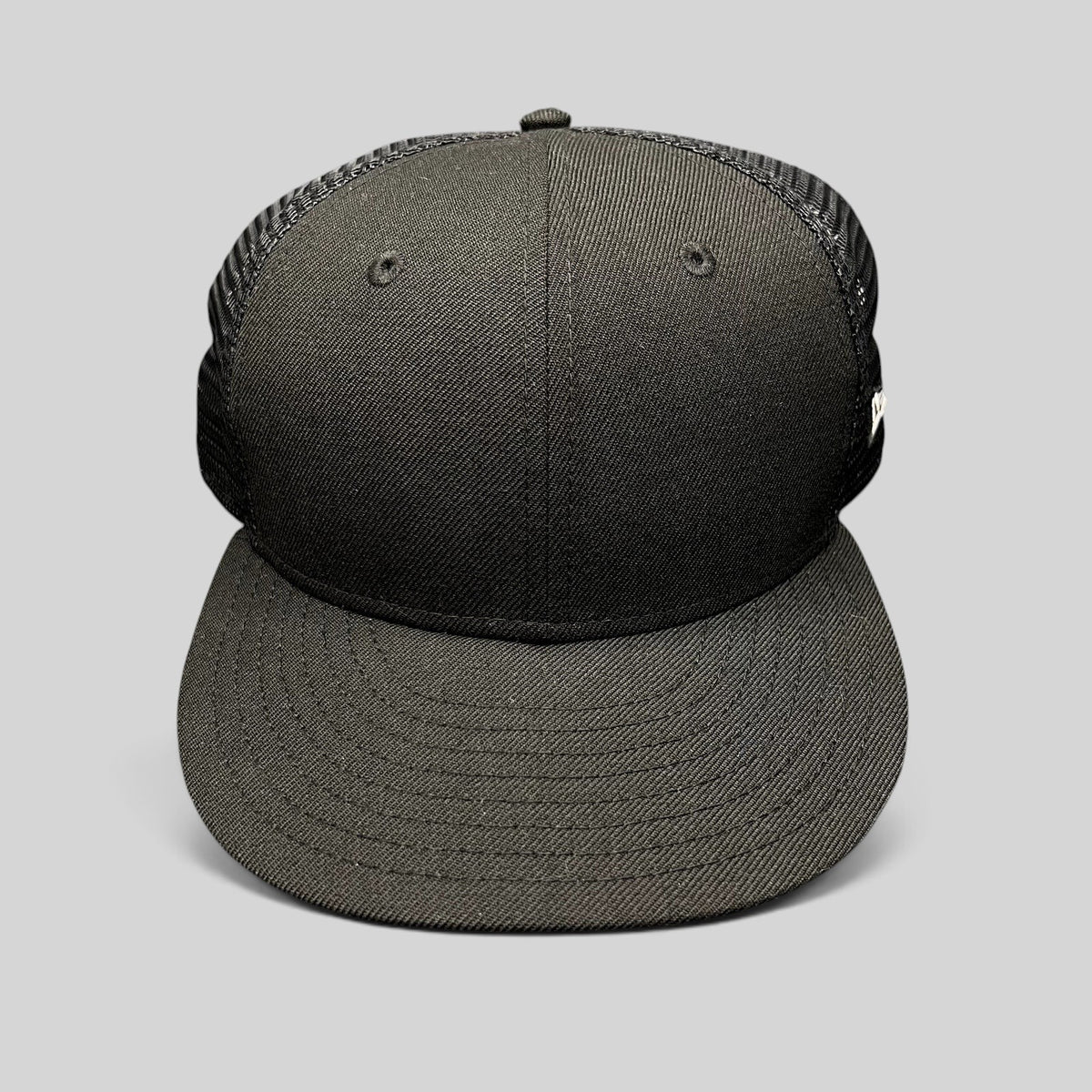 Raree Finds black New Era 59FIFTY blank fitted trucker hat with a structured high crown and breathable mesh back.