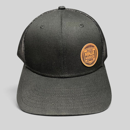 Raree Finds black American Ninja Warrior Crew trucker snapback hat with a round leatherette patch and mesh back.