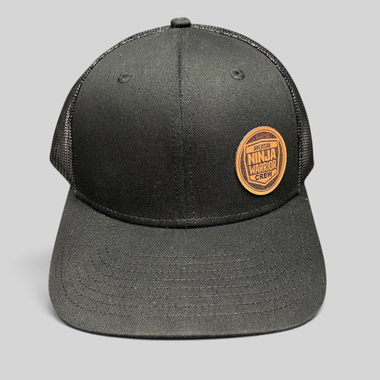 Raree Finds black American Ninja Warrior Crew trucker snapback hat with a round leatherette patch and mesh back.