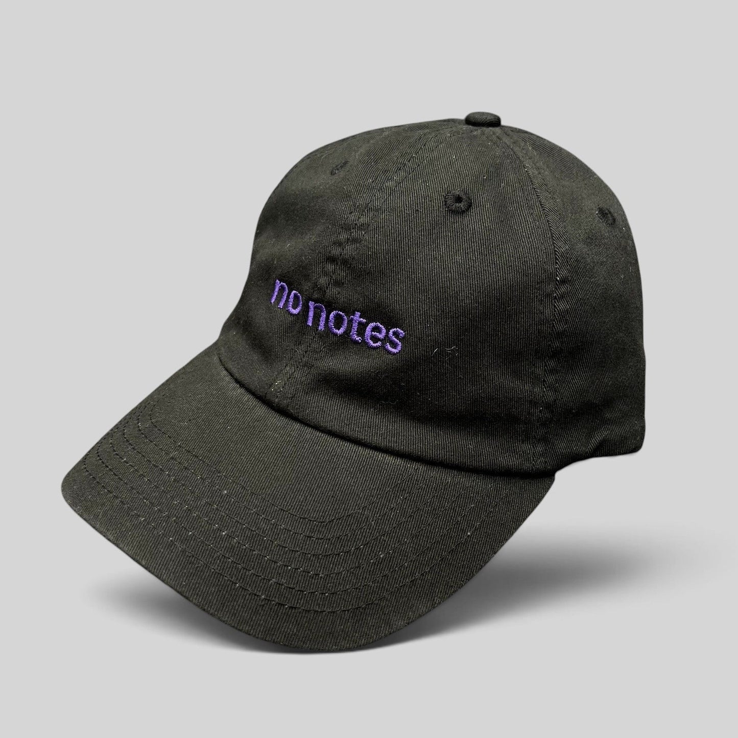 Raree Finds black cotton twill dad hat with purple embroidered No Notes text on the front