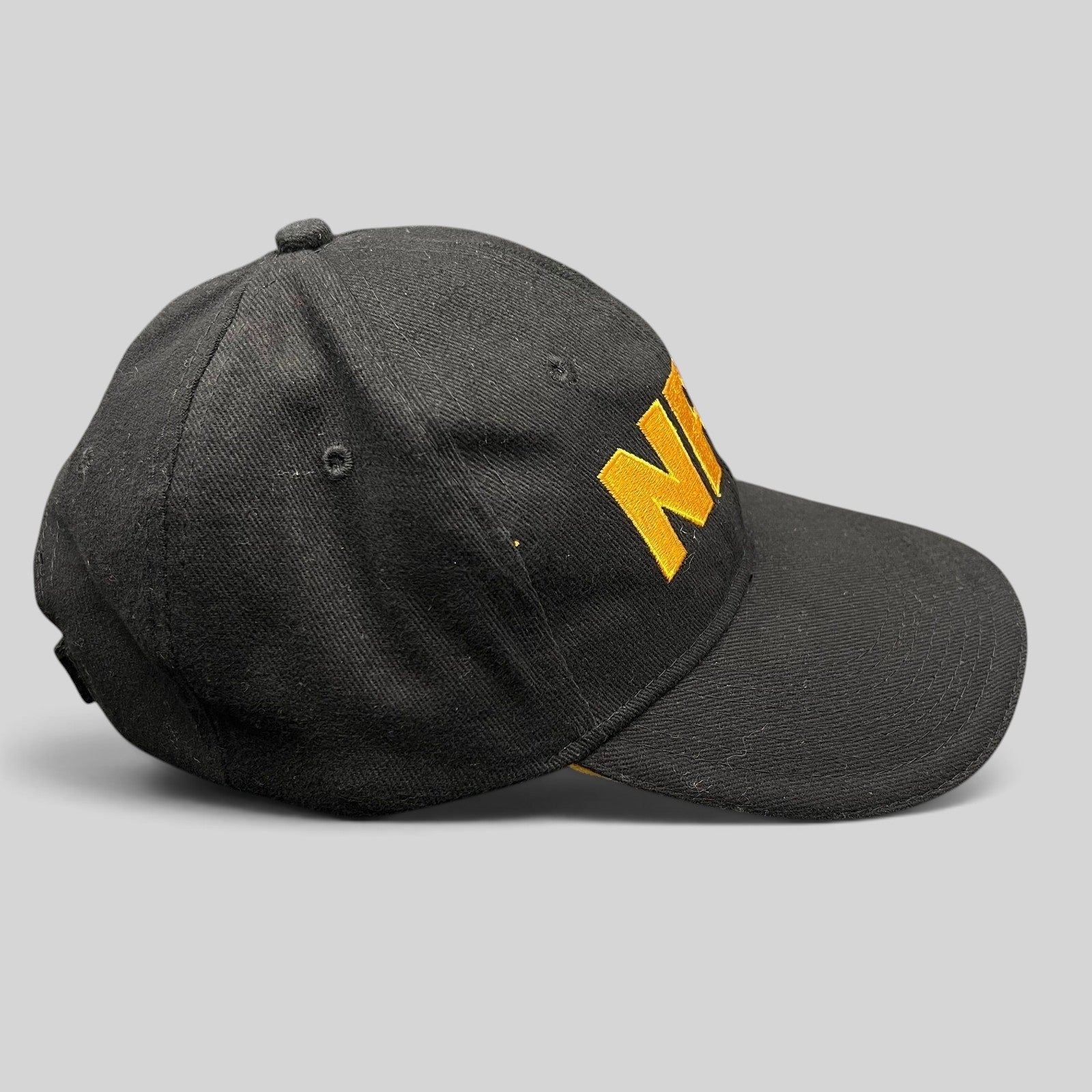 Raree Finds black strapback hat with bold yellow embroidered NRA logo on the front and a curved brim