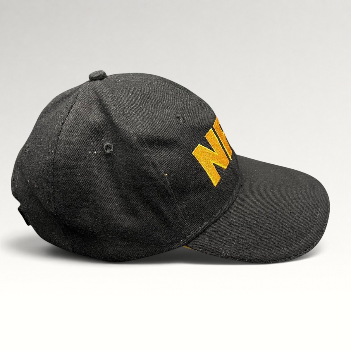 Raree Finds black strapback hat with bold yellow embroidered NRA logo on the front and a curved brim