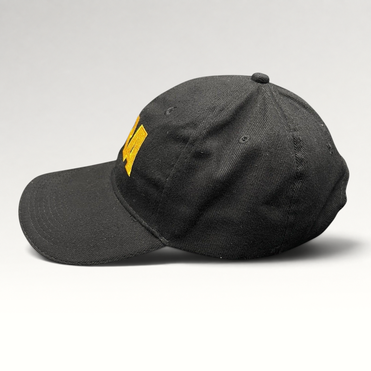 Raree Finds black strapback hat with yellow embroidered NRA logo and curved brim in a classic 6-panel design