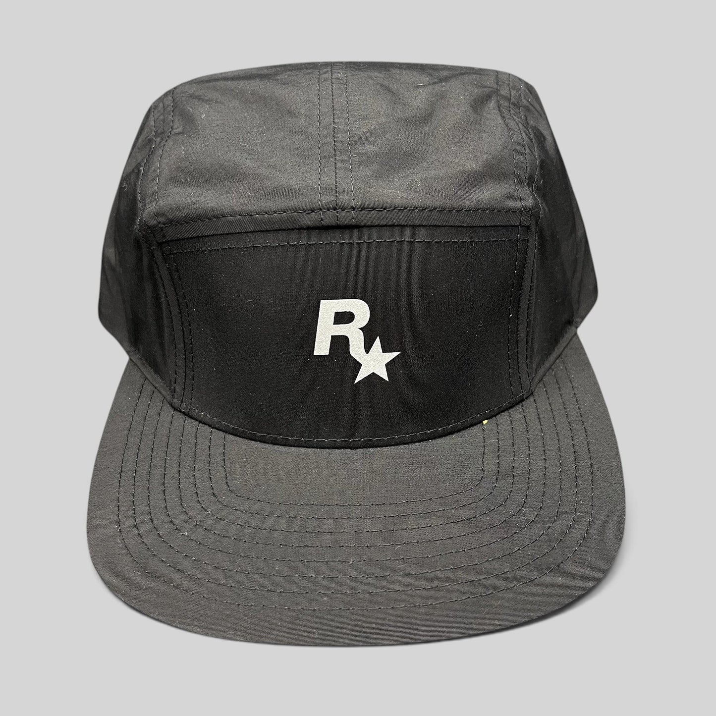 Raree Finds black nylon 5-panel camp hat by Yupoong featuring a white Rockstar Games logo on the front