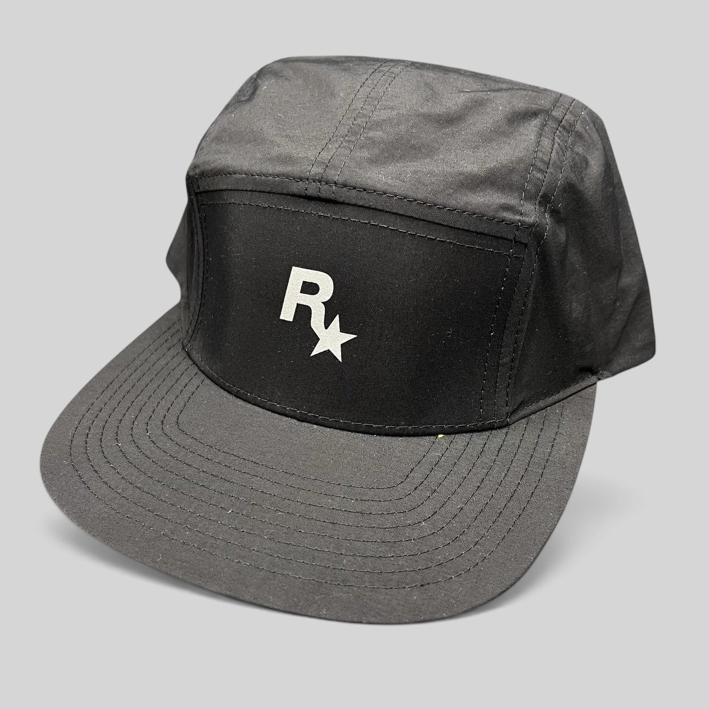 Raree Finds black nylon 5-panel camp hat with white Rockstar Games logo and flat brim