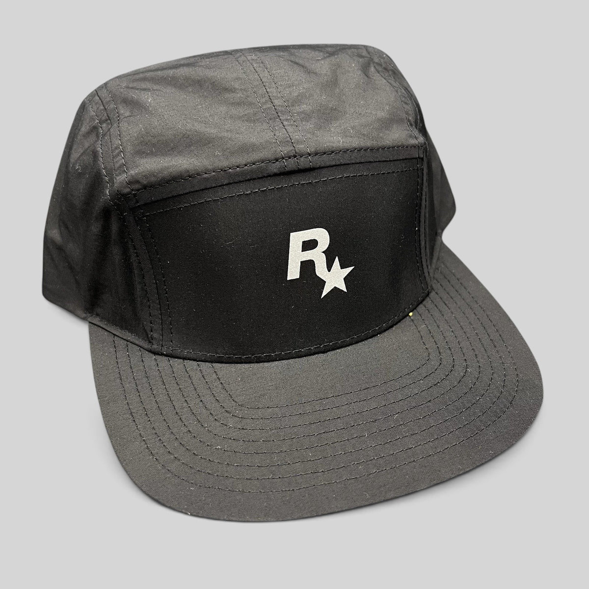 Raree Finds black nylon 5-panel camp hat featuring a white Rockstar Games logo on the front with a flat brim.