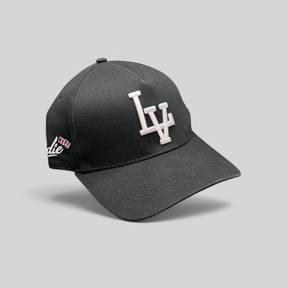 Raree Finds black Okami Brand strapback hat with white embroidered LV logo and side script detailing.