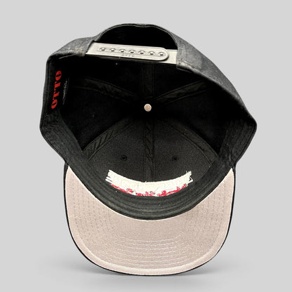 Raree Finds black OTTO snapback hat interior view showing structured crown, flat brim, and adjustable snap closure.