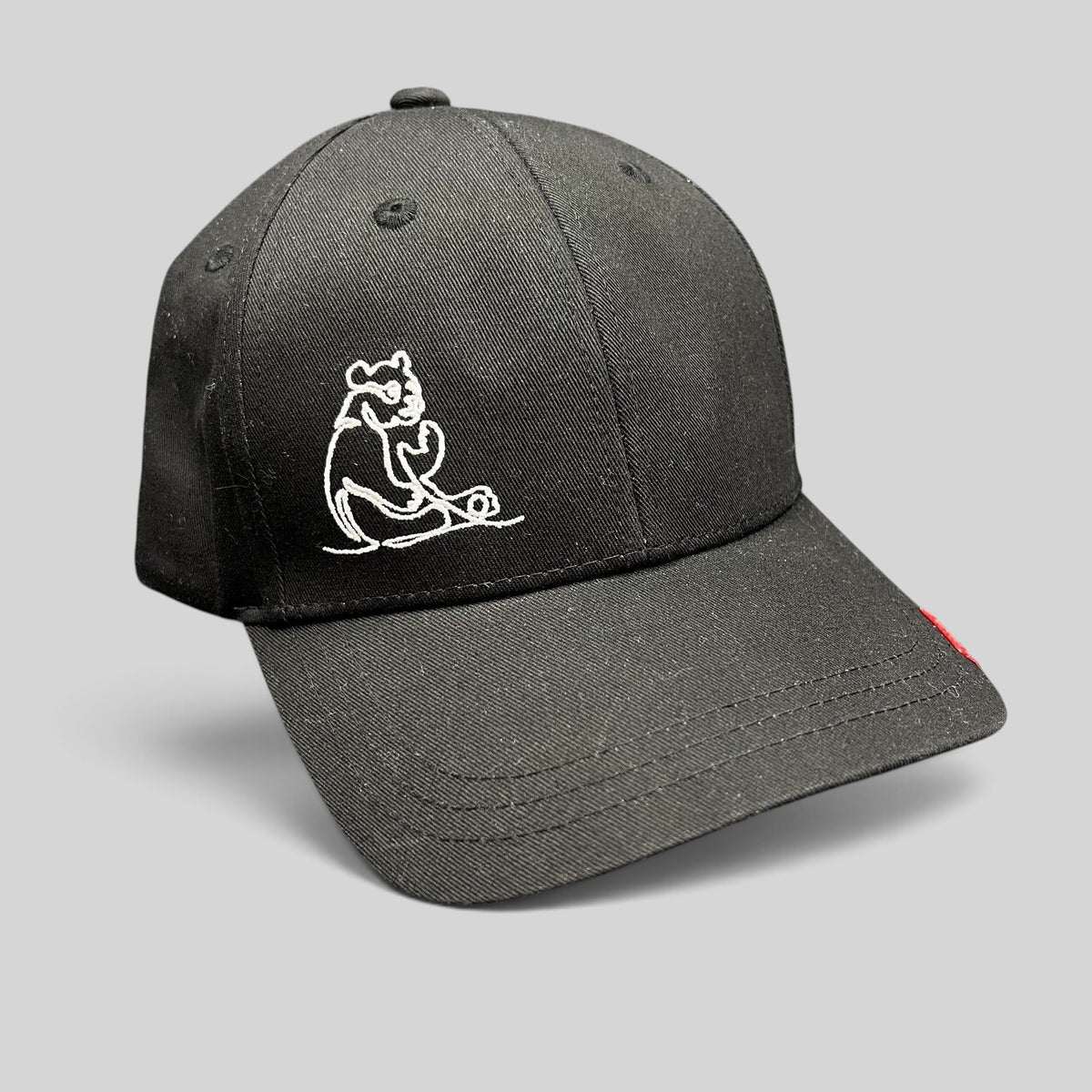 Raree Finds black six-panel strapback hat featuring a minimalist white embroidered panda graphic.