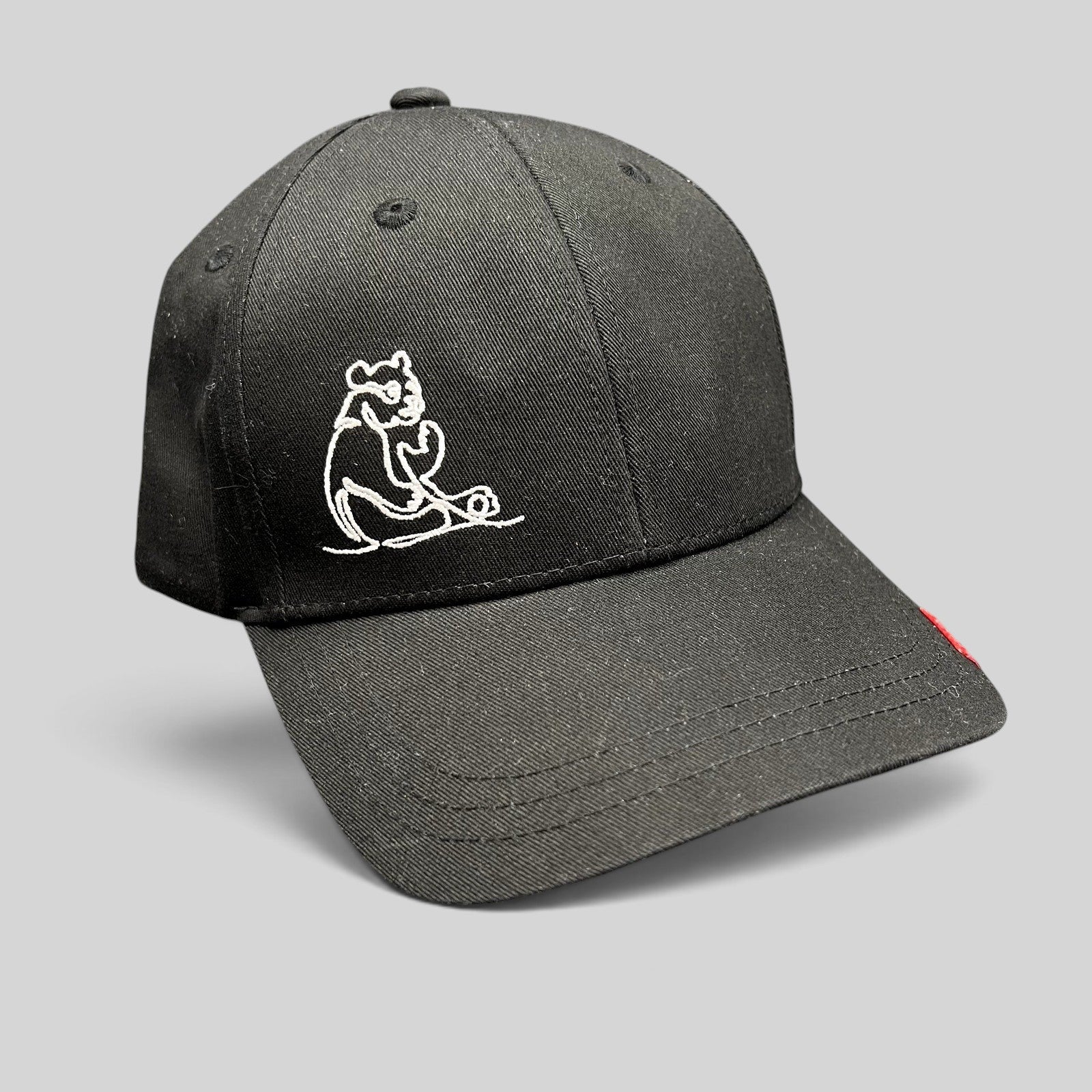 Raree Finds black six-panel strapback hat featuring a minimalist white embroidered panda graphic.