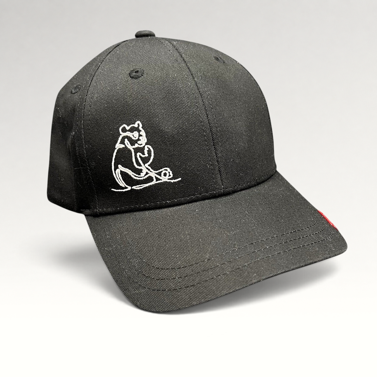 Raree Finds black strapback cap featuring a minimalist white embroidered panda graphic on the front panel.