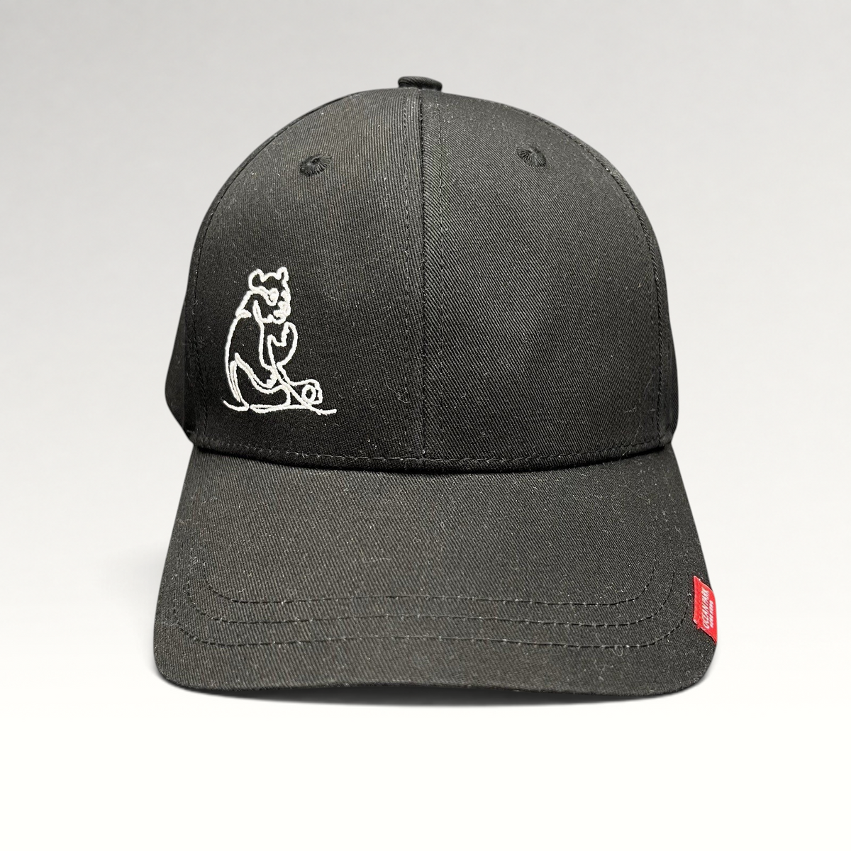 Raree Finds black strapback cap with minimalist white embroidered panda graphic and small red side logo tag