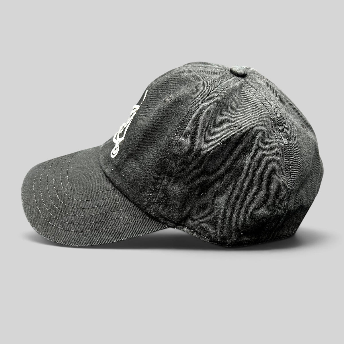 Raree Finds black cotton strapback hat featuring white embroidered Panic! At The Disco logo on a curved brim cap
