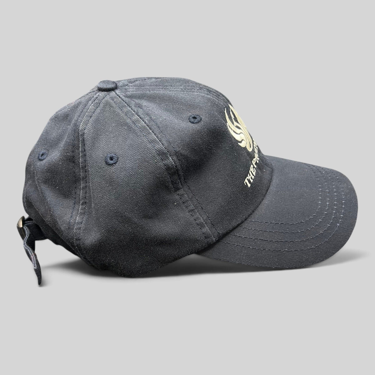 Raree Finds black cotton strapback hat featuring The Phoenician Scottsdale embroidered logo and curved brim.