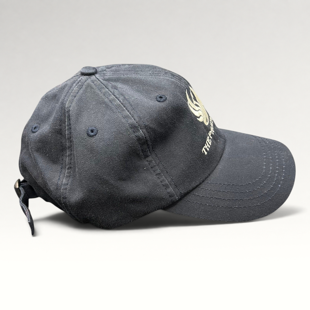 Raree Finds black cotton strapback hat featuring The Phoenician Scottsdale embroidered logo and curved brim.