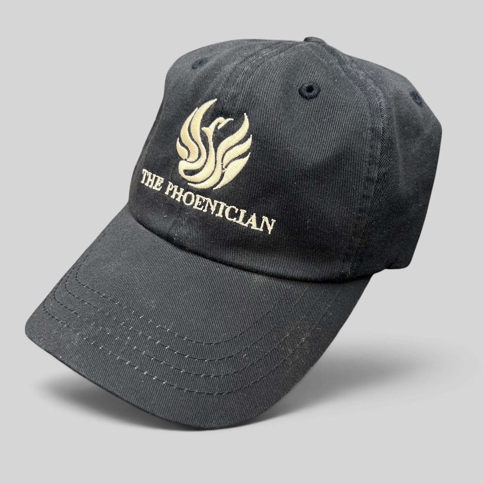 Raree Finds black cotton strapback hat featuring The Phoenician Scottsdale embroidered logo and curved brim.