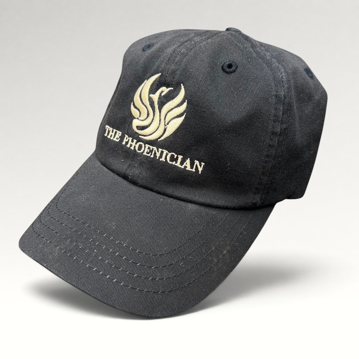 Raree Finds black cotton strapback hat featuring The Phoenician Scottsdale embroidered logo and curved brim.