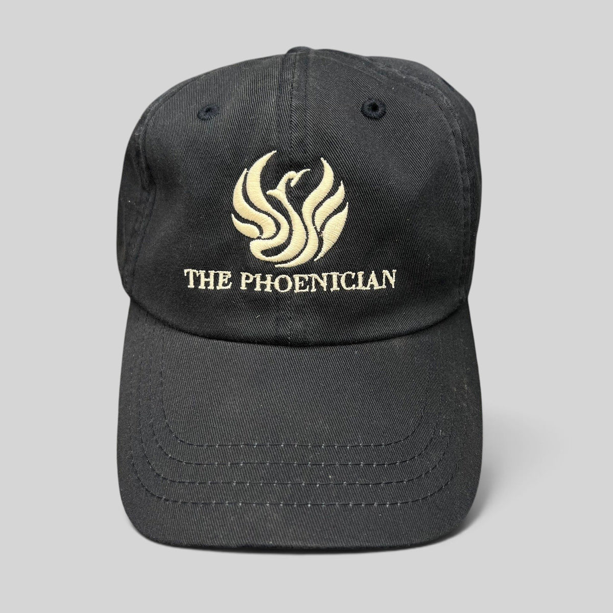 Raree Finds black cotton strapback dad cap with embroidered The Phoenician phoenix logo and script on the front