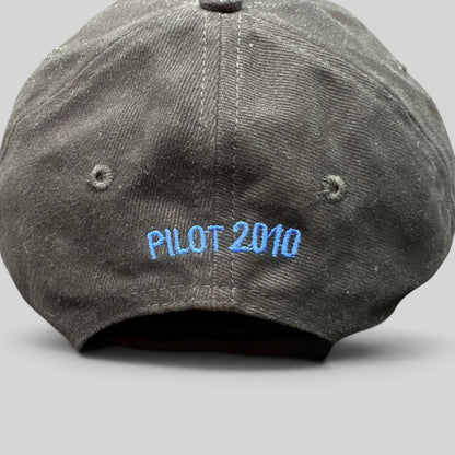 Raree Finds black cotton crew hat with blue embroidered text reading PILOT 2010 on the back panel