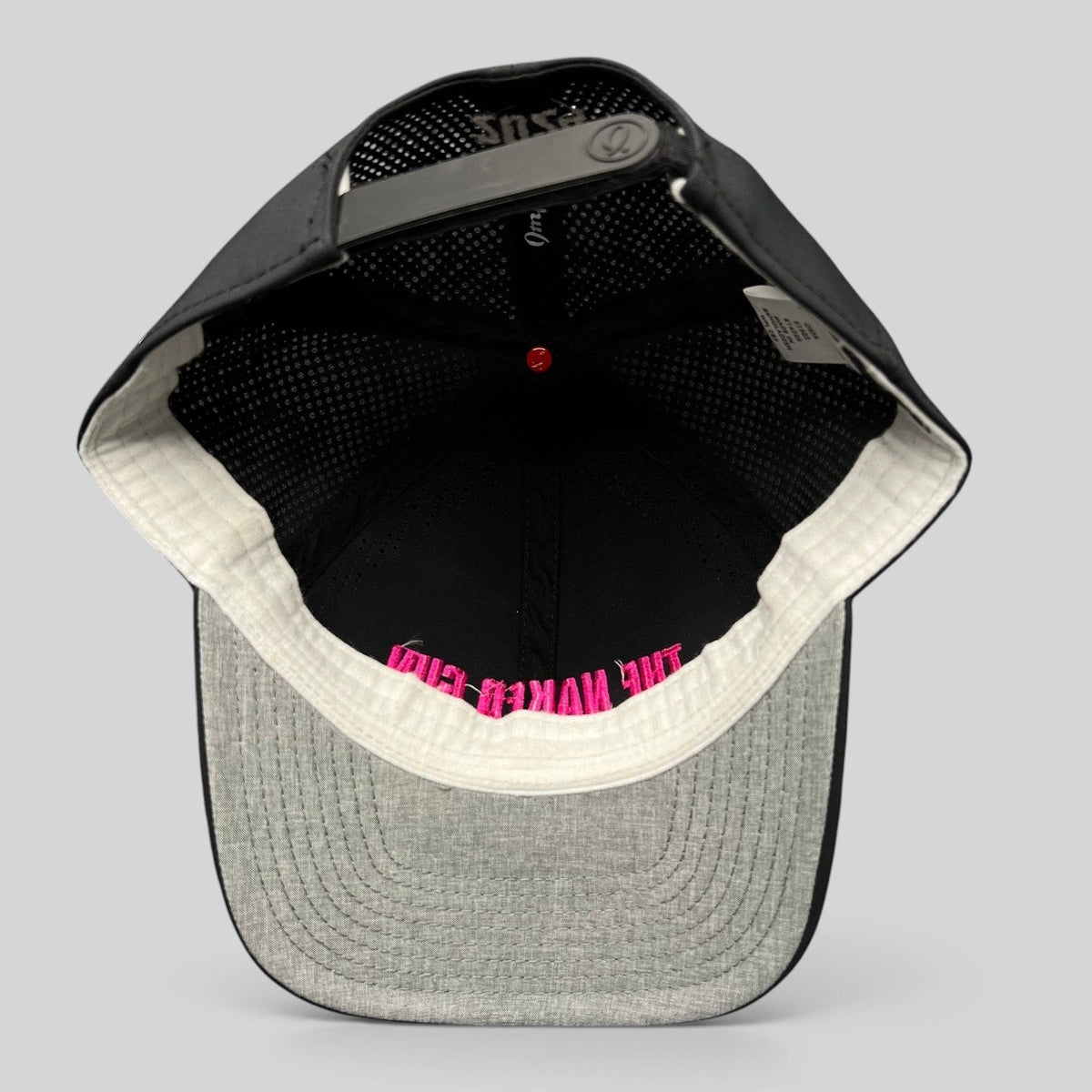 Raree Finds black performance snapback hat with pink The Naked Gun embroidery, showing interior construction.