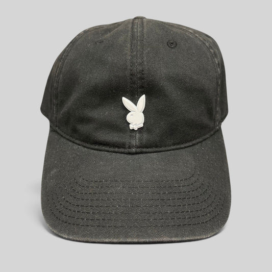 Raree Finds black strapback hat featuring a minimalist silver metal Playboy bunny logo on the front crown.