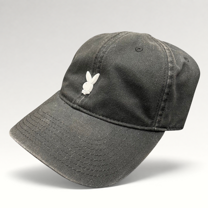 Raree Finds black cotton strapback hat featuring a minimalist raised metal Playboy bunny logo on the front crown.