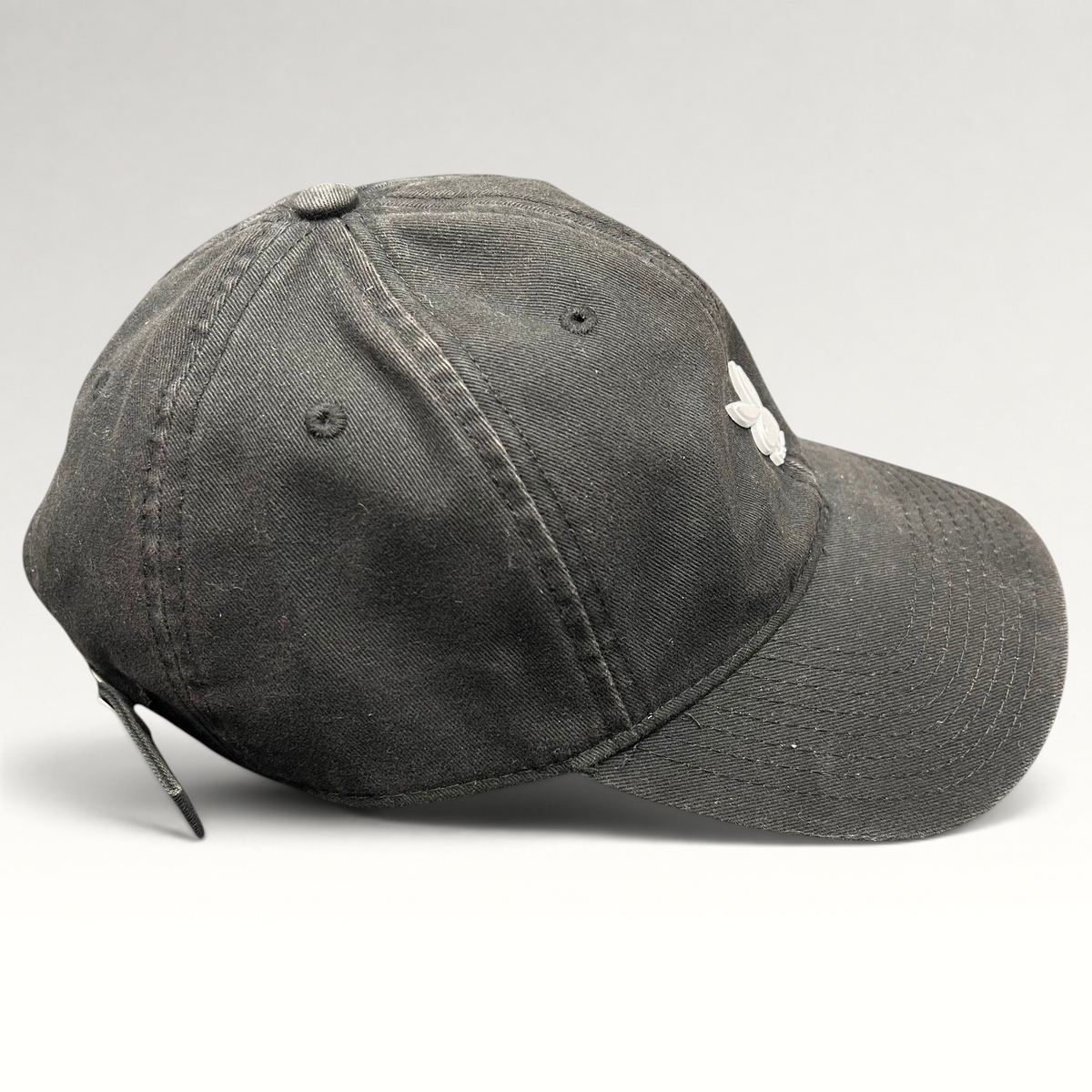 Raree Finds black cotton strapback hat with a minimalist metal Playboy bunny logo on the front crown