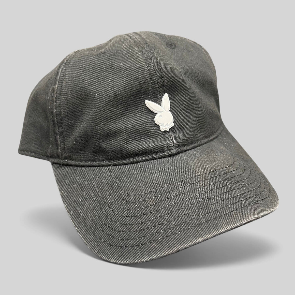 Raree Finds black cotton strapback hat featuring a minimalist silver metal Playboy bunny logo on the front crown