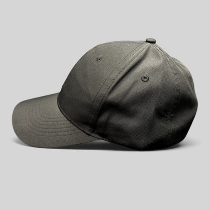 Raree Finds black polyester strapback hat with a curved brim and unstructured profile, side view.