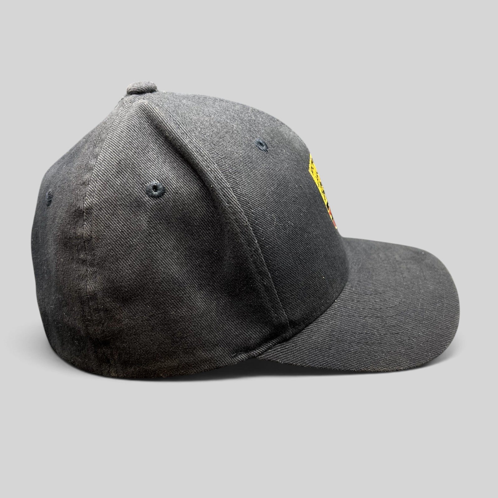 Raree Finds black Porsche Woodland Hills Flexfit cap with embroidered crest logo, side profile view.