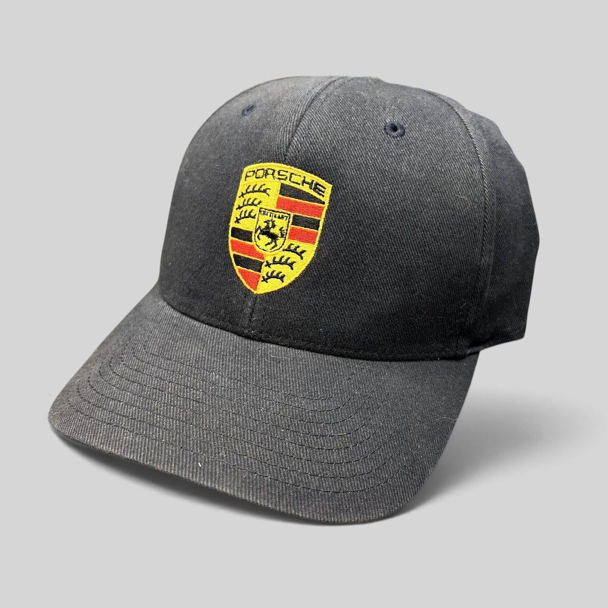 Raree Finds black Porsche Woodland Hills Flexfit cap with embroidered crest logo on the front